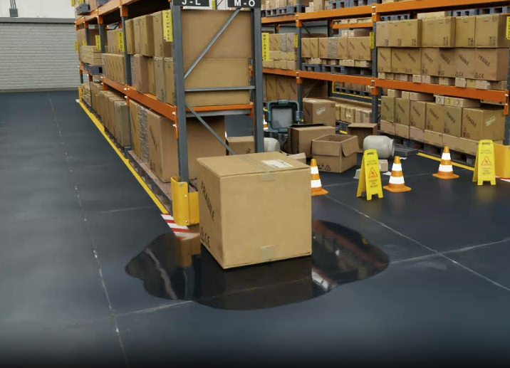liquid leaking from a box on the floor of a warehouse